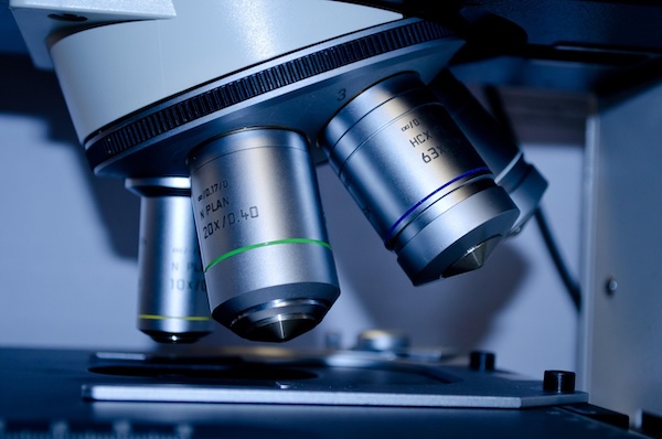 A close-up of the different lens of a microscope